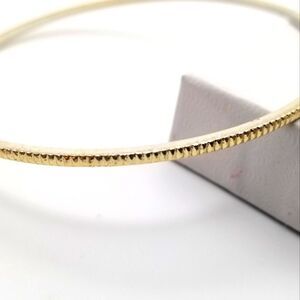 Gold tone etched bumpy road bracelet. B708